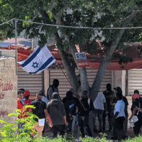 ACTIVISTS AT AN ANTI-HAITIAN RALLY CALLED BY THE ANCIENT DOMINICAN ORDER (AOD) FLY THE ISRAELI FLAG MOMENTS BEFORE VIOLENCE ERUPTS, ON MARCH 30, 2025. (PHOTO: CARMEN PARSONS)